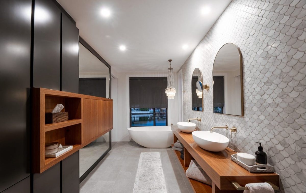 Master ensuite at 28 Kookaburra Court, Sorrento, featuring full height feature tiles, custom timber vanity, freestanding bath, and custom shelving and mirrors