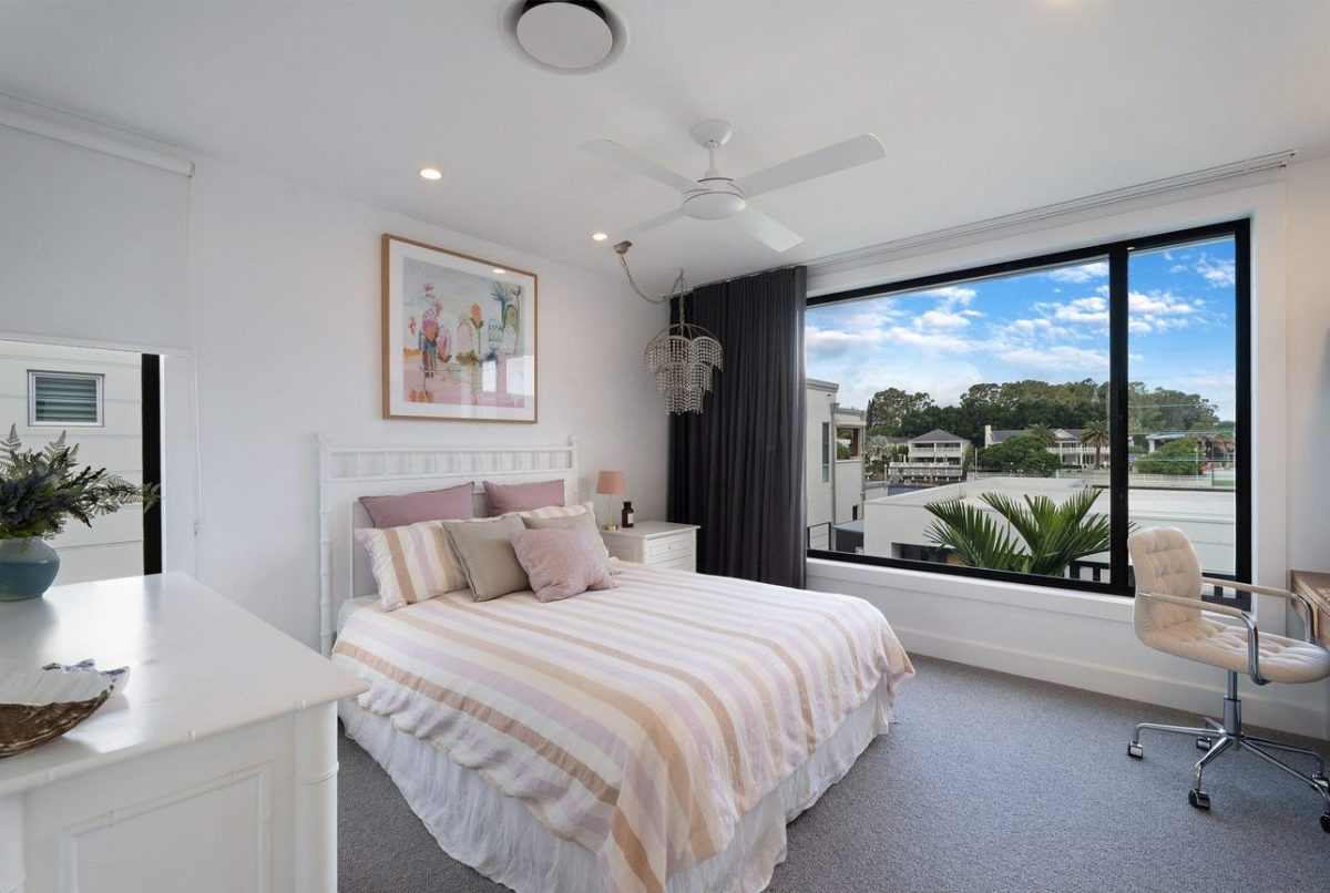 Bedroom 2 at 28 Kookaburra Court, Sorrento, featuring light airy colours, a desk, and views of the courtyard and surrounding suburb