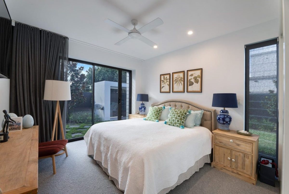 Bedroom 3 at 28 Kookaburra Court, Sorrento, featuring a bed, bedside drawers, study desk, and views of the outdoor area