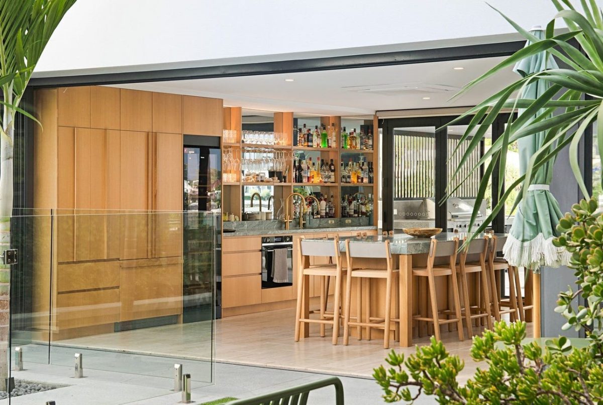 Close-up shot of the entertainment area at 28 Kookaburra Court, Sorrento, featuring a bar, island bench, integrated cabinetry face fridge, and wine fridge