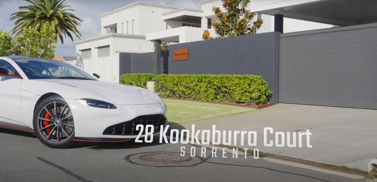 Aston Martin pulling into the driveway at 28 Kookaburra Court, Sorrento, with tilt-up concrete fencing, gate house, electric gate, and sign reading ‘Casa la Belle