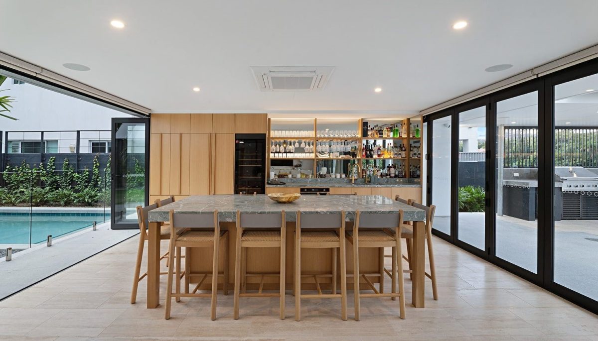 Entertainment room at 28 Kookaburra Court, Sorrento with stone benchtop island, bar, and views of the pool and BBQ area