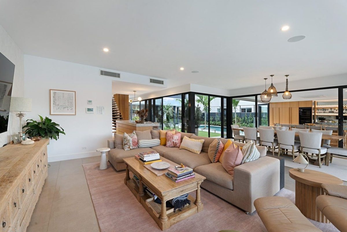 Ground floor living room at 28 Kookaburra Court, Sorrento, with adjacent dining area, kitchen, and views of the courtyard and pool