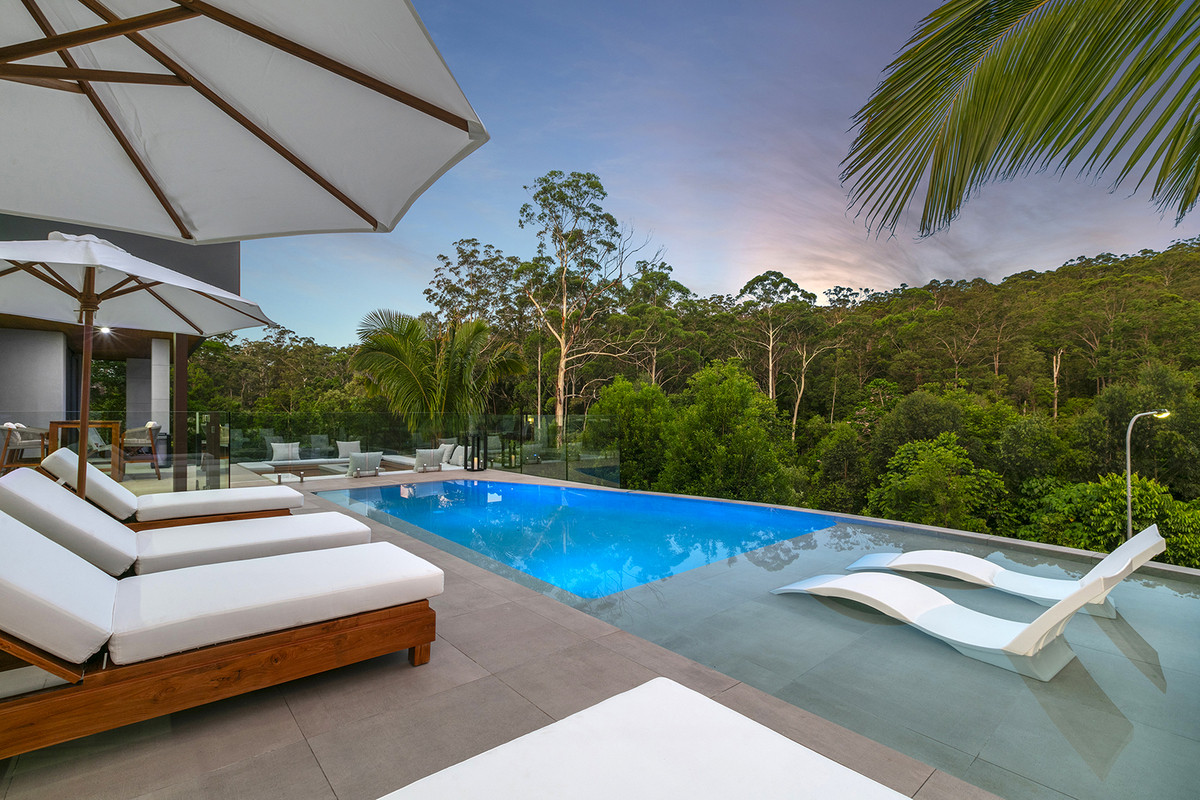 View of the swimming pool from the gate, with the hinterland in the background at 74 Anning Road, Forest Glen.