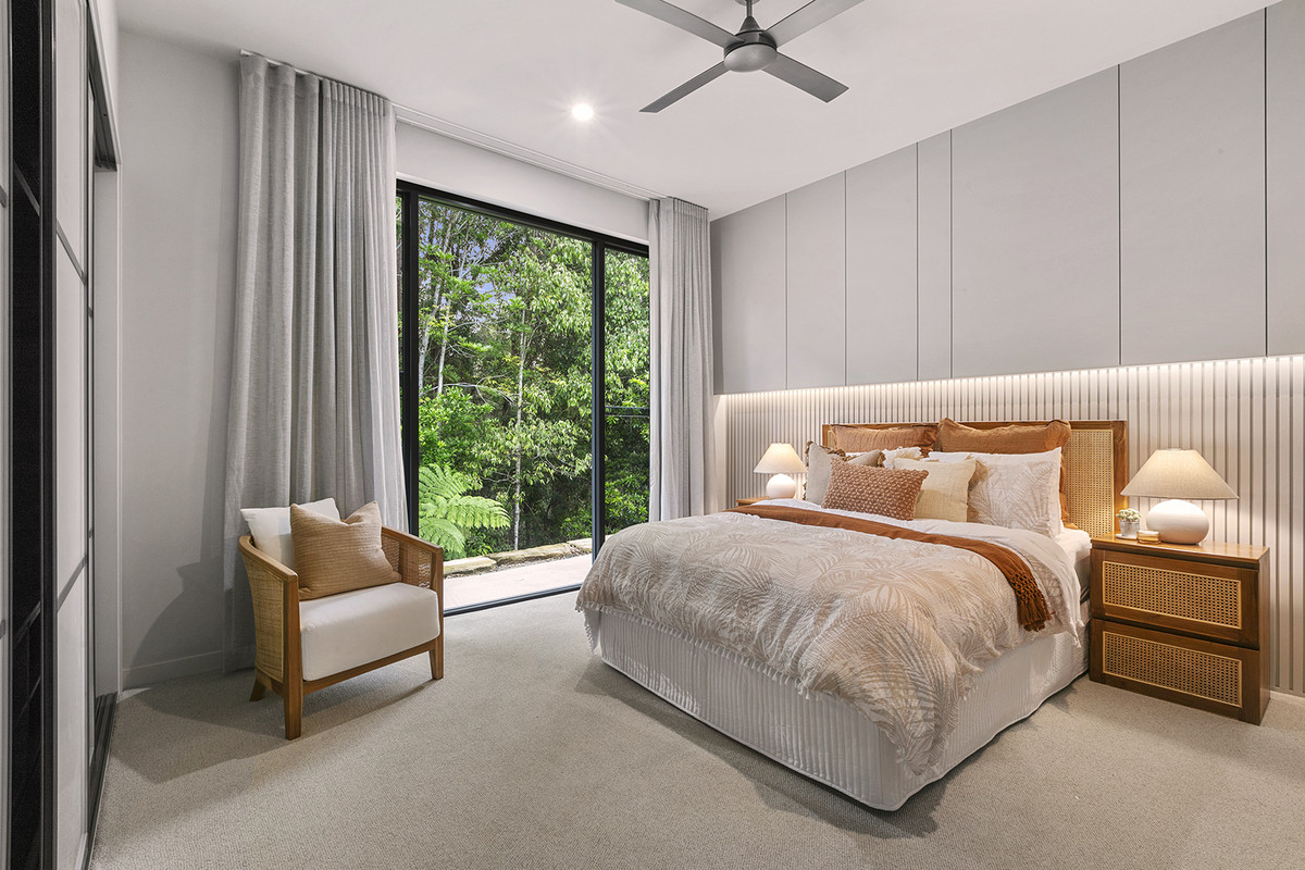 Bedroom 3 at 74 Anning Road, Forest Glen, featuring a queen bed, feature cladding bed head, and hinterland view.