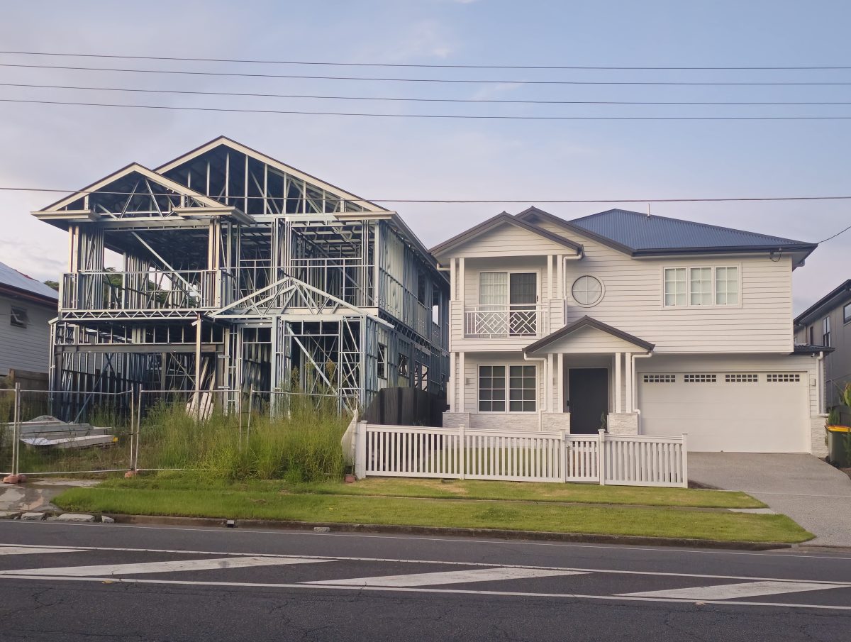 Two Australian Houses, one is a steel frame home currently Under Construction and the other is a Completed white weatherboard style House