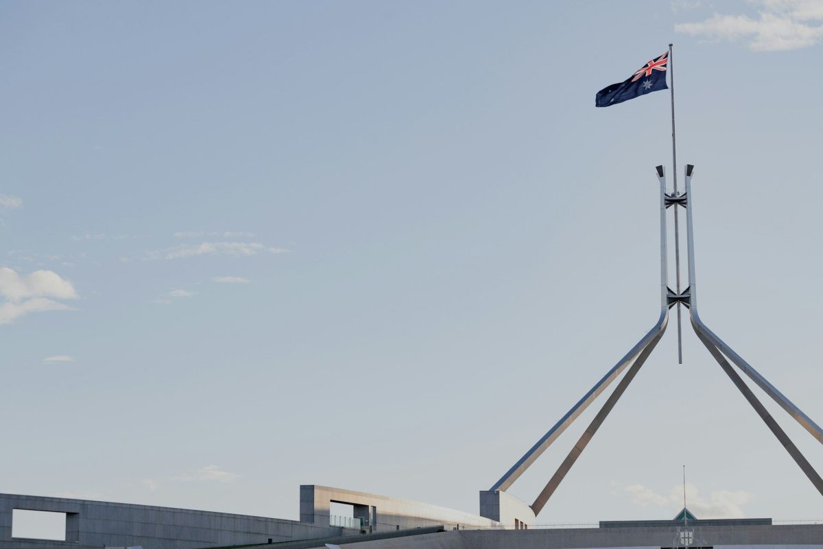 Australian flag flying high above parliament house